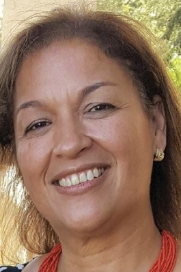A headshot of woman in her 50s smiling at camera
